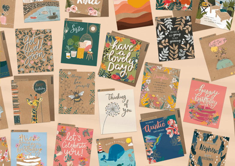 A range of greetings cards, laid flat on a light coloured backgroud.