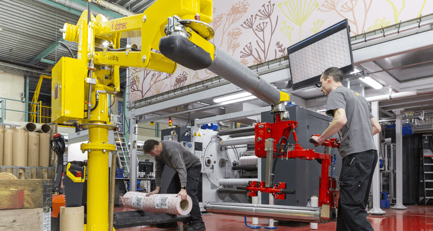 Two Design Group employees work in a production facility. 