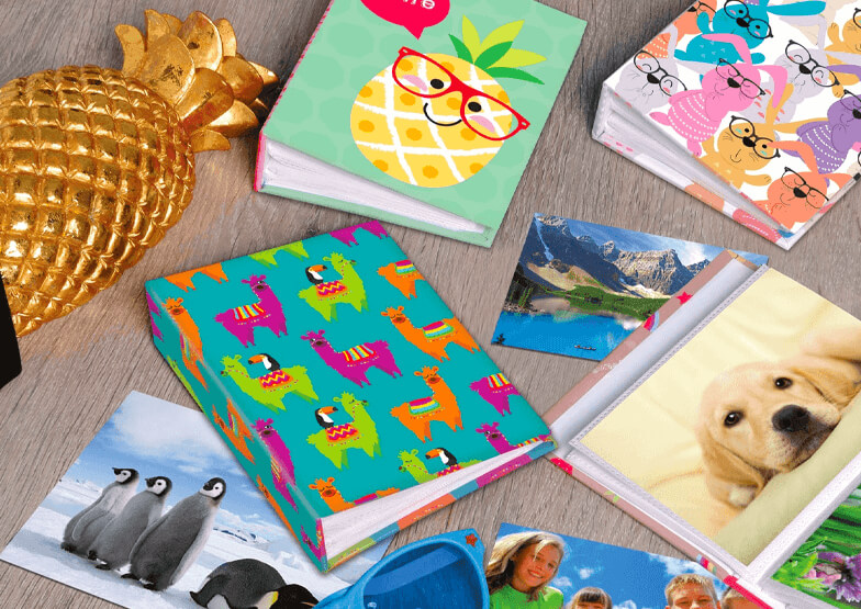 A range of photo albums laid on a wooden table 